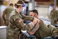 Officer receives the Pfizer-BioNTech COVID-19 vaccine.