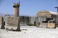 An Afghan Army soldier walks at the gate of Bagram Air Base in Afghanistan.