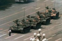 A man stands alone to block a line of tanks heading east on Beijing's Tiananmen Square.