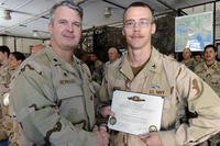 Intelligence specialist receives designator.