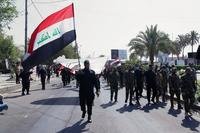 Iran-backed militia fighters march in central Baghdad, Iraq