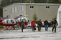 Ketchikan Volunteer Rescue Squad personnel land and disembark from a Hughes 369D helicopter.