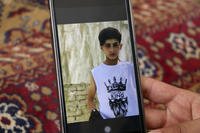 Emal Ahmadi shows a photo of his family member who was killed during a U.S. drone strike