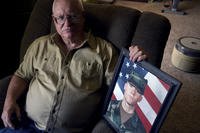 Vietnam veteran Donn Edmunds sits in his living room in Wyoming.