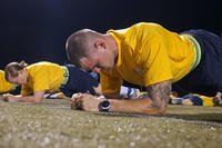 Officer Candidates School students perform planks during physical fitness assessment.