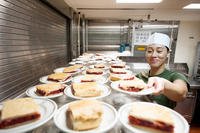 A Marine prepares desserts for the crew.