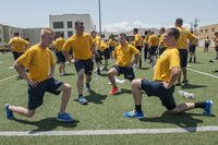 Sailors perform lunges during command physical training.