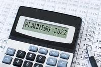 Calculator with display reading &quot;Planning 2022&quot;