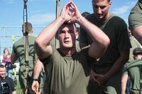 A Marine does lunges with the TRX suspension system.