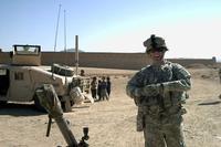 Brian Thompson laughs near local children while on patrol in Afghanistan