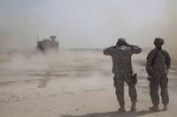 U.S. Army soldiers cover their ears during artillery qualification