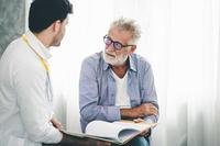 Older man talking to doctor
