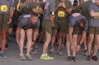 Runners stretch before the 2013 Marine Corps Marathon Forward at Camp Leatherneck, Afghanistan.