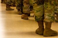 Army National Guard soldiers wait in line to receive COVID-19 vaccination