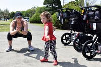A coordinator of the Camp Zama Stroller Warriors does strength training with her daughter.