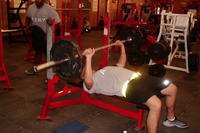 An Army soldier works on the bench press during remedial PT on Contingency Operating Base Adder, Iraq.