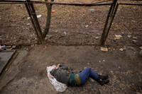 body of a man lies on the ground, in Bucha, Ukraine