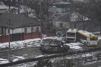 A Russian army tank moves through a street on the outskirts of Mariupol.