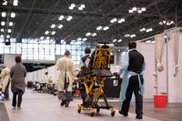 Service members transport a patient at the Javits New York Medical Station.