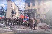 Russian troops waving Russian and Chechen republic national flags.