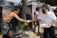 Actor Danny Trejo shakes hands with homeless Gulf War veteran.