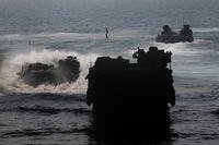 Marines aboard amphibious assault vehicles depart the well deck of amphibious assault ship USS Bataan (LHD 5).