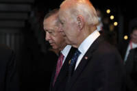 Turkish President Recep Tayyip Erdogan walks with U.S. President Joe Biden. 