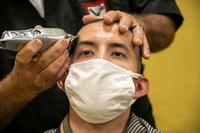 A Marine recruit receives his initial haircut.