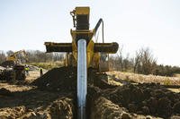 DeWind construction worker uses the trencher to dig a 30-foot-deep trench at Wright-Patterson Air Force Base