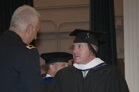 Maj. Gen. Bennet S. Sacolick (left), commanding general of the U.S. Army John F. Kennedy Special Warfare Center and School, congratulates Maj. Michael Yeager during a ceremony on his completion of a master's degree program run at SWCS by the National Defense University.