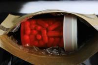 A bottle of pills inside a shipping envelope