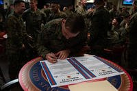 U.S. Marine Corps Sgt. Joshua M. Kivett, president of the Non Commissioned Officer Association, signs the mission statement for the newly formed Non-Commissioned Officer Association on Camp Lejeune, North Carolina.
