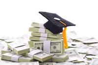 a graduation cap perches on a stack of cash