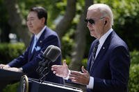 South Korea's President Yoon Suk Yeol listens as President Joe Biden speaks