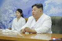 North Korean leader Kim Jong Un, right, and his daughter visit the country's aerospace agency
