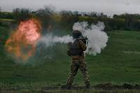 A Ukrainian soldier fires an RPG during his training at the frontline positions