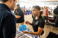 Tameka Cunningham-Preyer, Air Force Installation and Mission Support Center program and management analysts, speaks with a prospective new civilian hire at a Joint Base San Antonio civilian hiring event at St. Philip’s College, San Antonio.