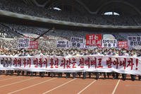Pyongyang people take part in a demonstration after a mass rally