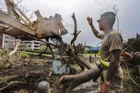 Guam National Guard soldier helps remove debris after Typhoon Mawar.