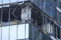 Investigators examine a damaged skyscraper in Moscow, Russia.