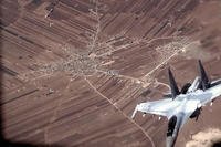 Russian Su-35 flies near a U.S. Air Force MQ-9 Reaper drone