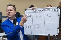 Rep. Jared Moskowitz, D-Fla., holds up a whiteboard