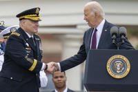 President Joe Biden, right, shakes hands with outgoing Joint Chiefs Chairman Gen. Mark Milley