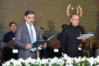 President Arif Alvi, right, administers oath from Anwaar-ul-Haq Kakar as caretaker Prime Minister during a ceremony