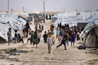 Children gather outside their tents at the al-Hol camp, which houses families of members of the Islamic State group
