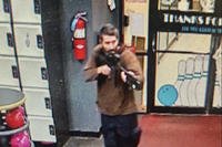 unidentified gunman points a gun while entering Sparetime Recreation in Lewiston, Maine