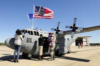 U.S. Air Force Senior Airman Damien Williams (right), 145th Aircraft Maintenance Squadron, and his family look at the 145th Airlift Wing, Mini C-130 Hercules aircraft during Family Day at the North Carolina Air National Guard Base, Charlotte-Douglas International Airport.