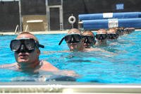Basic crewman training candidates tread water in a pool while waiting for instructions during their first physical screening test at Naval Amphibious Base, Coronado in California.