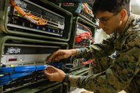 U.S. Marine Corps Lance Cpl. Michael Linardakis checks computer connections to internet servers on Kin Blue, Okinawa, Japan.