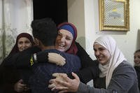 A Palestinian prisoner released by Israel is hugged by relatives.